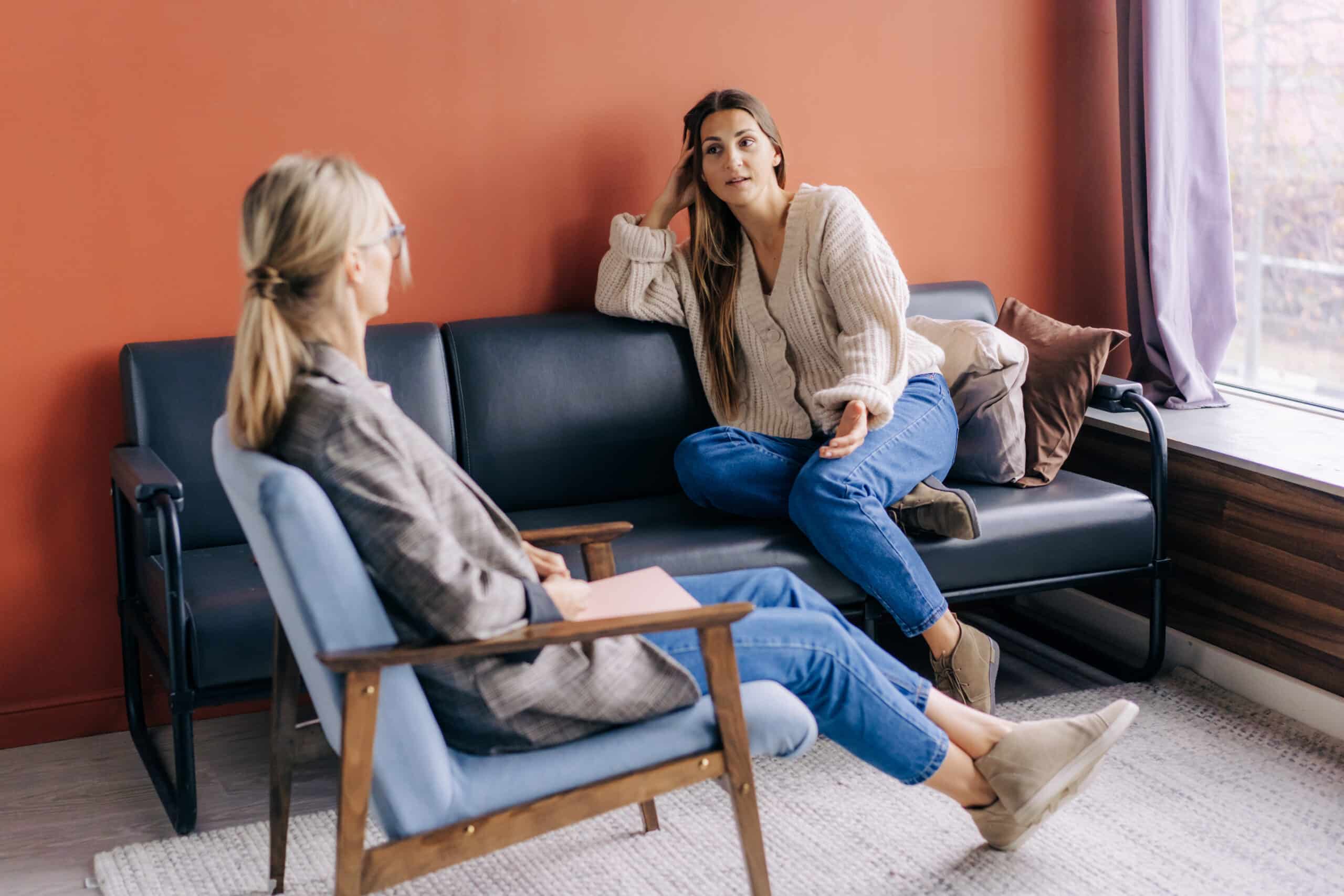 A female psychotherapist consults and gives advice and psychological support to a young woman.